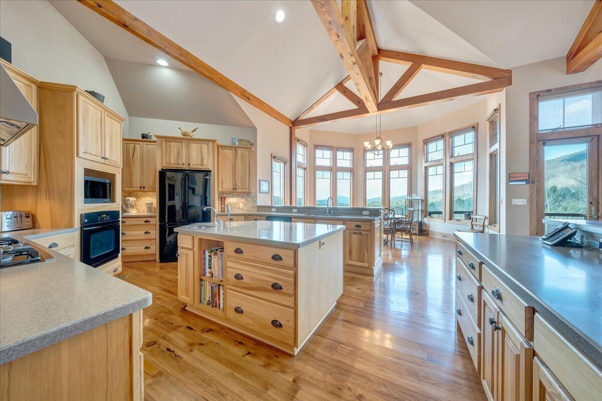 144 Seven Ridges Road Hot Springs, VA 24445 - Photo 17 of 89 a kitchen with stainless steel appliances granite countertop a lot of counter space and wooden floors