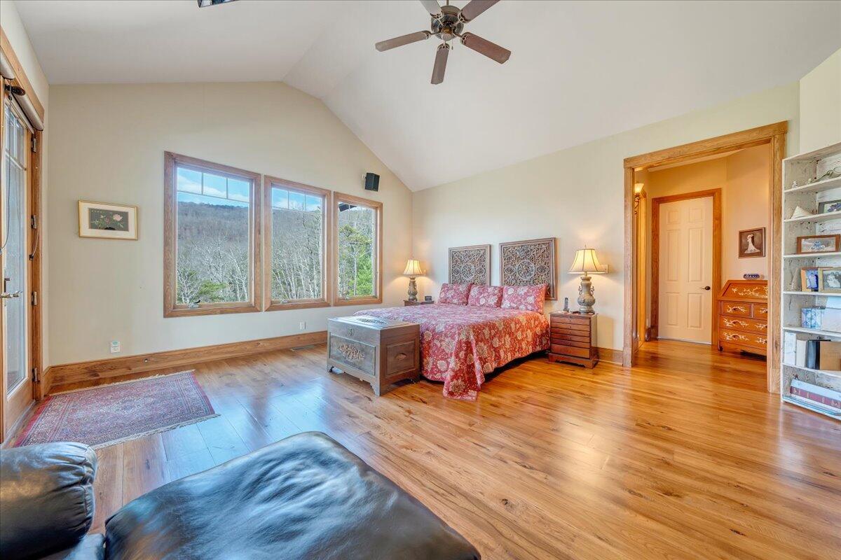 144 Seven Ridges Road Hot Springs, VA 24445 - Photo 31 of 89 a bedroom with a large bed and a wooden floor