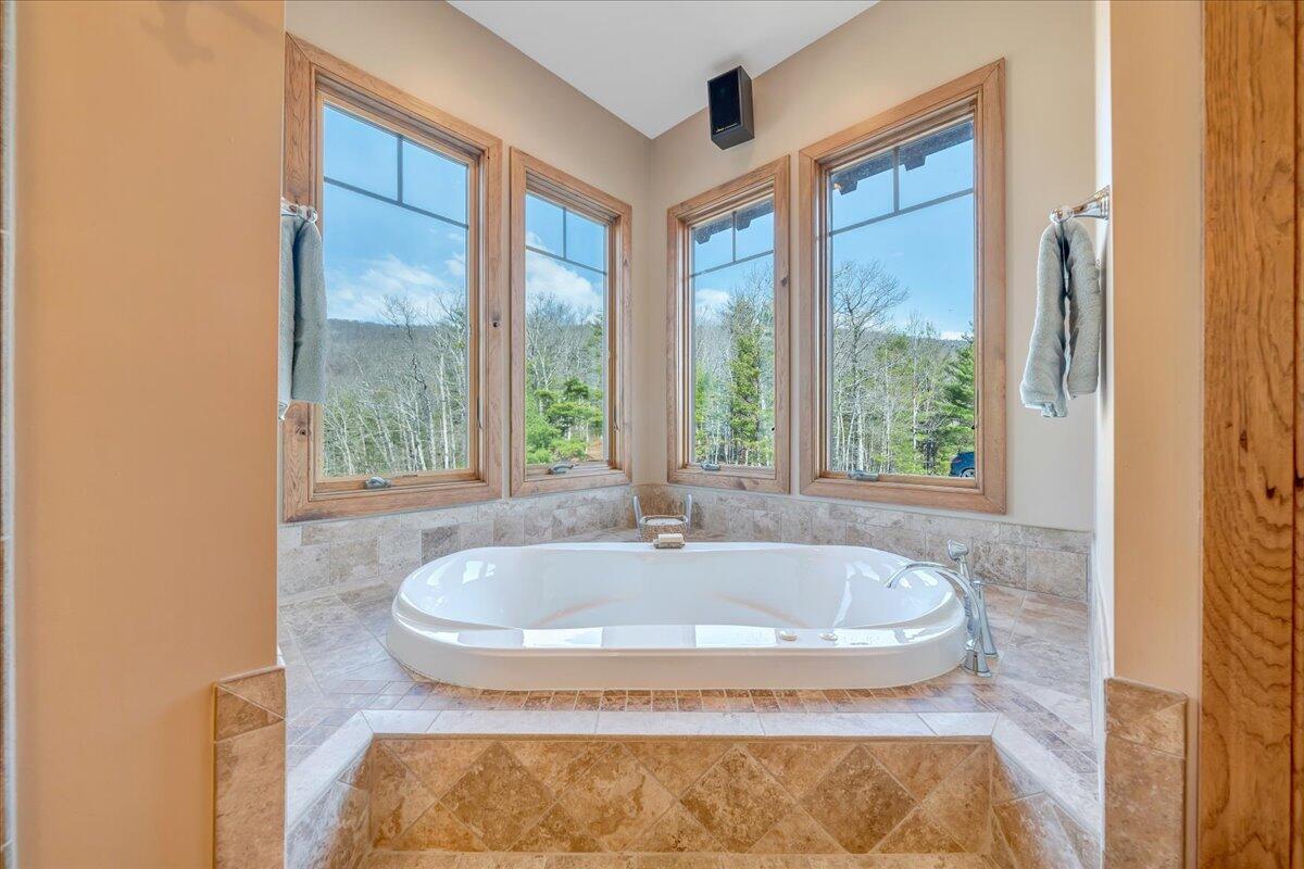 144 Seven Ridges Road Hot Springs, VA 24445 - Photo 36 of 89 a bath tub sitting in a bathroom next to a window