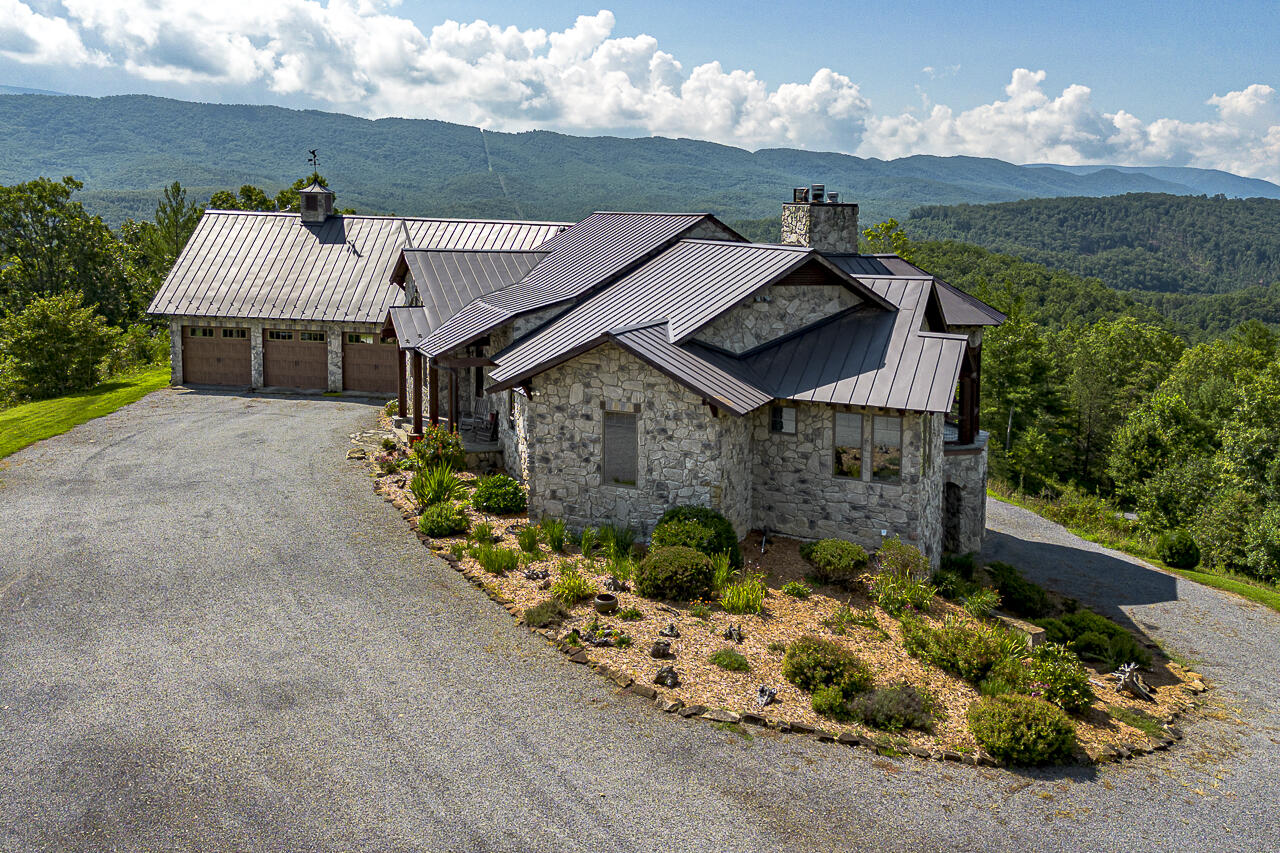 144 Seven Ridges Road Hot Springs, VA 24445 - Photo 4 of 89 a front view of a house with a yard and garage