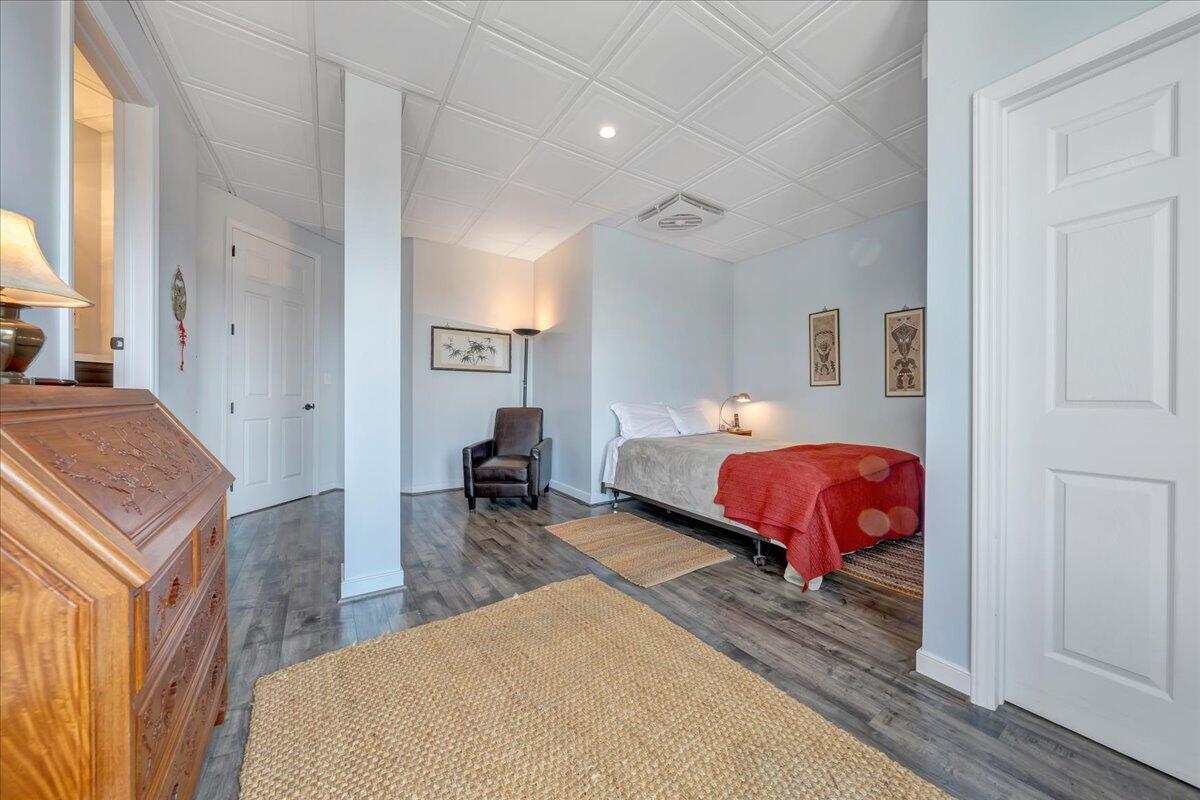 144 Seven Ridges Road Hot Springs, VA 24445 - Photo 62 of 89 a bedroom with a bed and a chandelier