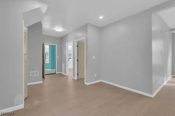 an empty room with windows and closet