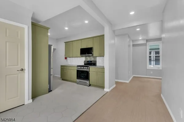 a kitchen with a refrigerator and a sink