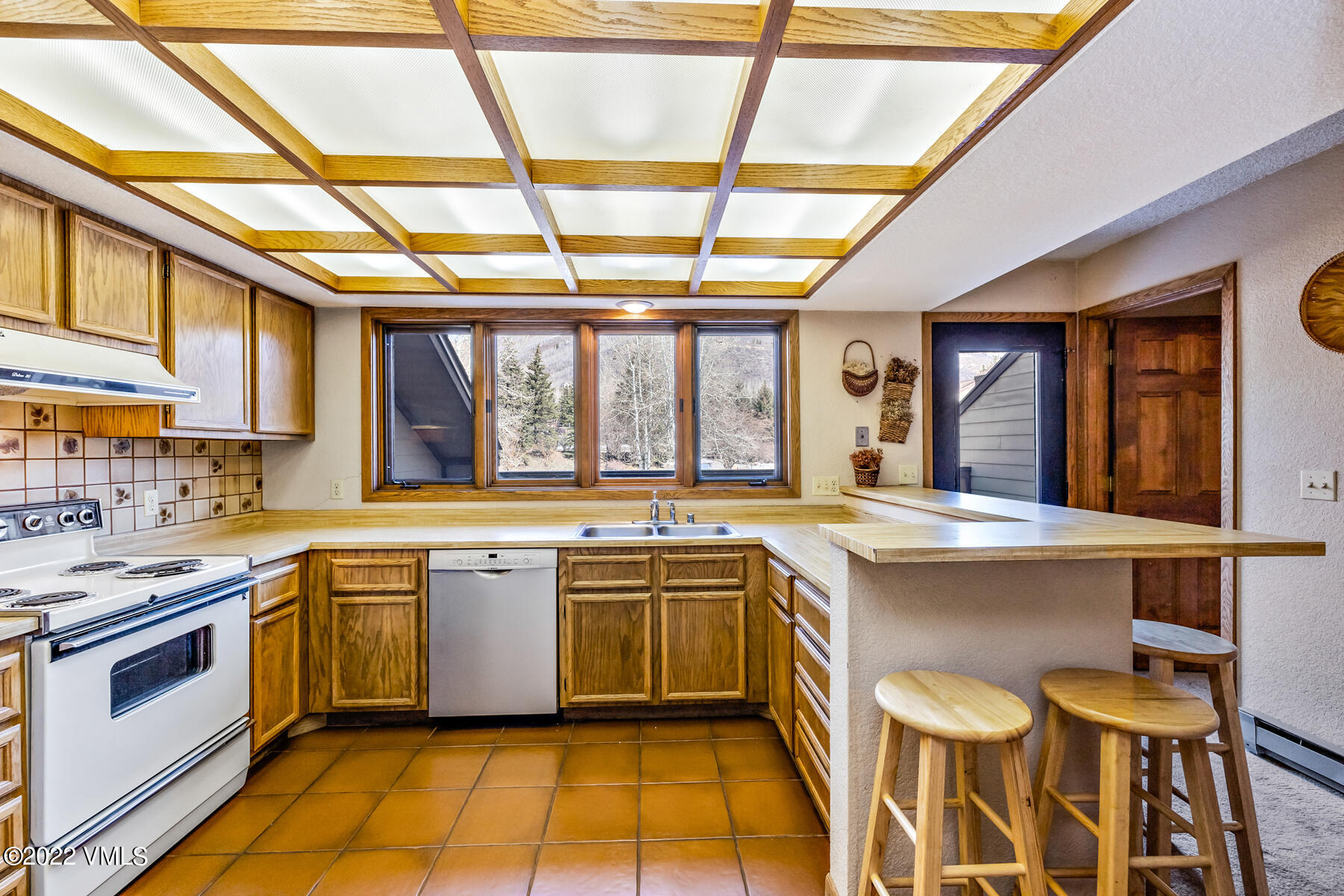 1750 South Frontage Road West, Unit E3 Vail, CO 81657 - Photo 12 of 39 a kitchen with a stove sink and cabinets