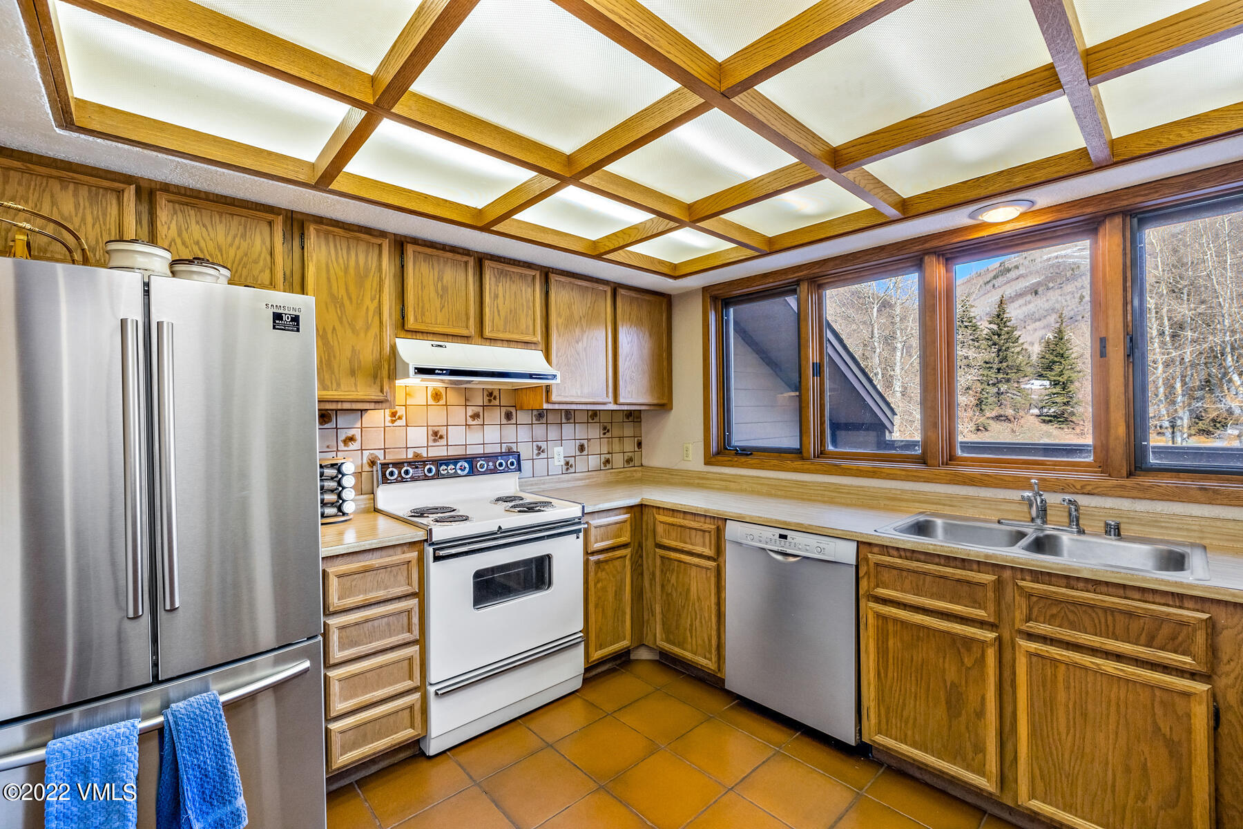 1750 South Frontage Road West, Unit E3 Vail, CO 81657 - Photo 13 of 39 a kitchen with a stove a sink and a refrigerator