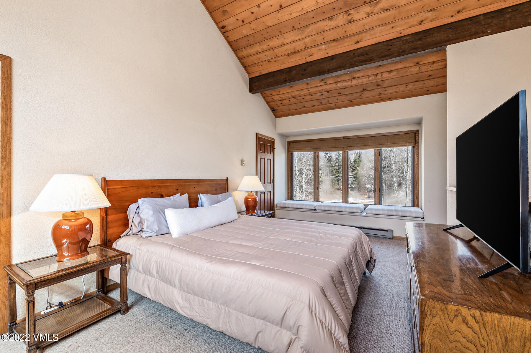 1750 South Frontage Road West, Unit E3 Vail, CO 81657 - Photo 16 of 39 a bedroom with furniture and a flat screen tv