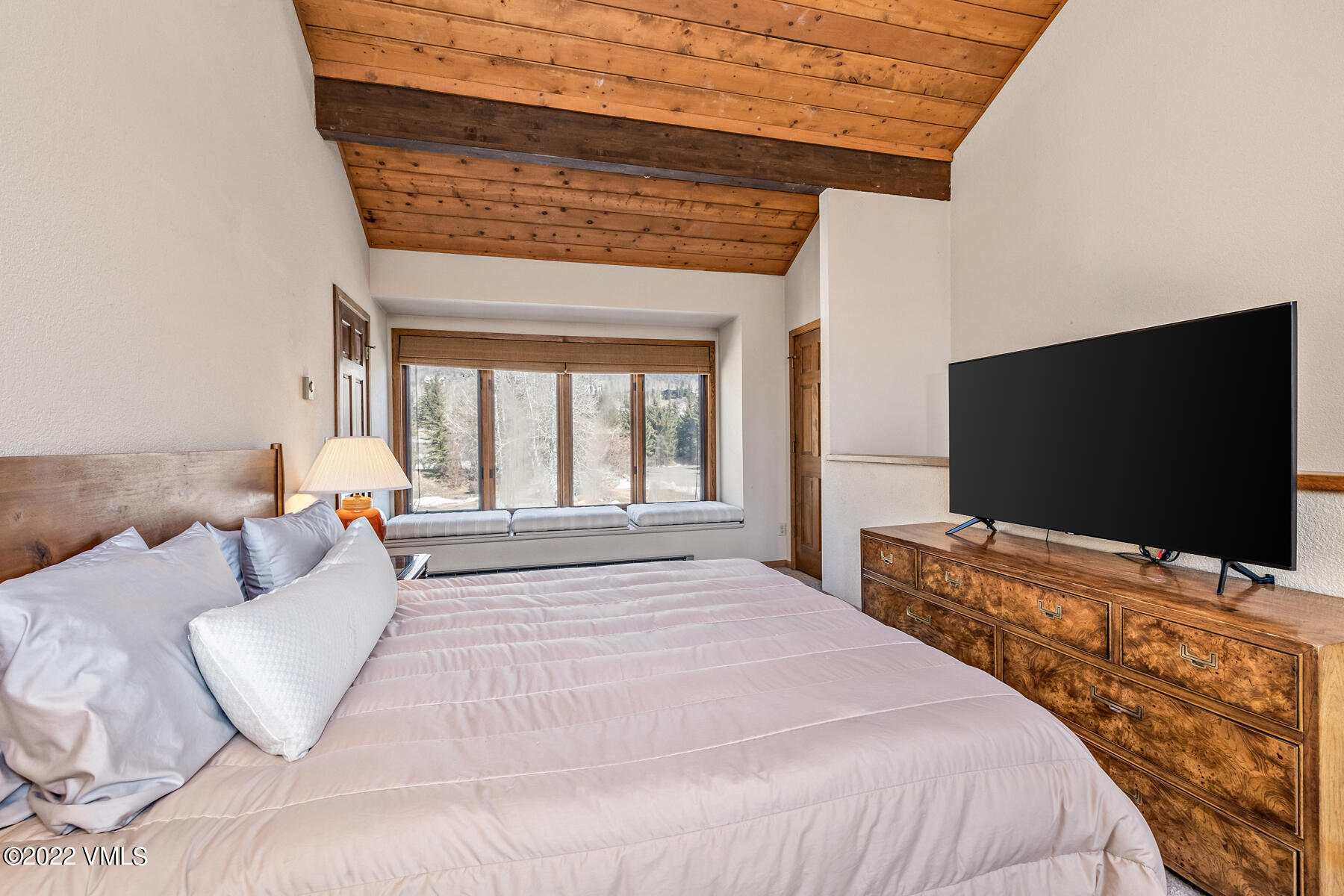 1750 South Frontage Road West, Unit E3 Vail, CO 81657 - Photo 17 of 39 a bedroom with a bed and a flat screen tv