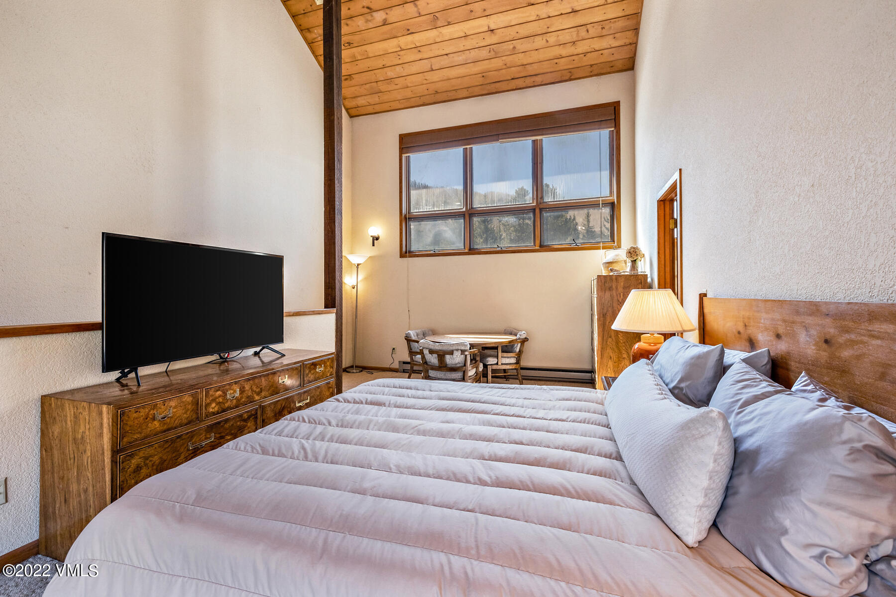 1750 South Frontage Road West, Unit E3 Vail, CO 81657 - Photo 18 of 39 a bedroom with a bed and flat screen tv