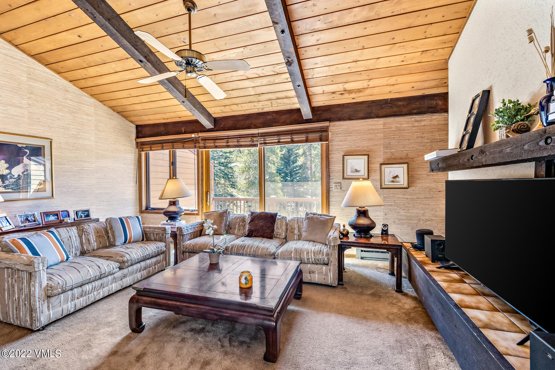 1750 South Frontage Road West, Unit E3 Vail, CO 81657 - Photo 2 of 39 a living room with furniture a flat screen tv and a large window