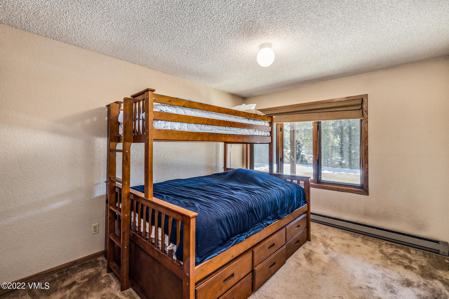 1750 South Frontage Road West, Unit E3 Vail, CO 81657 - Photo 21 of 39 a bedroom with a bed and window