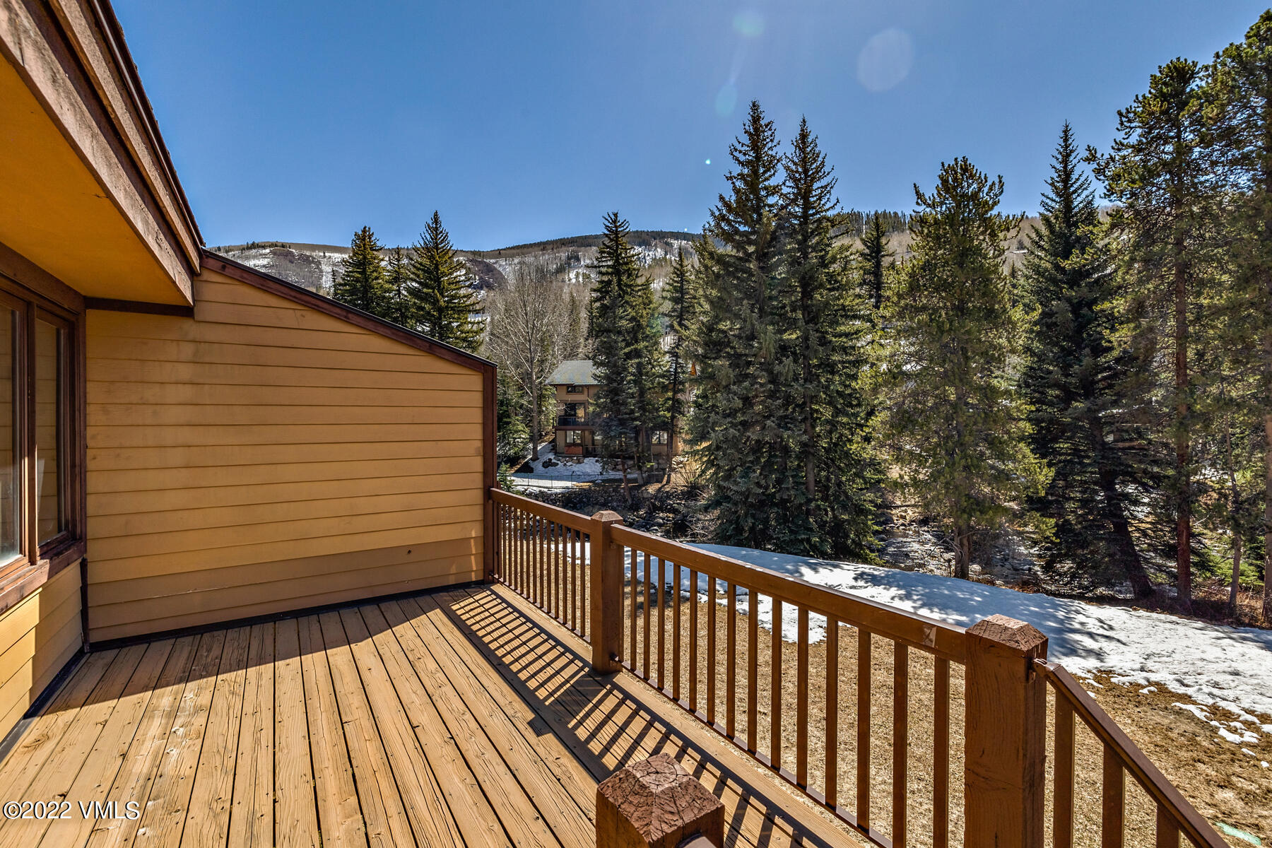 1750 South Frontage Road West, Unit E3 Vail, CO 81657 - Photo 4 of 39 a view of a balcony with wooden floor and fence