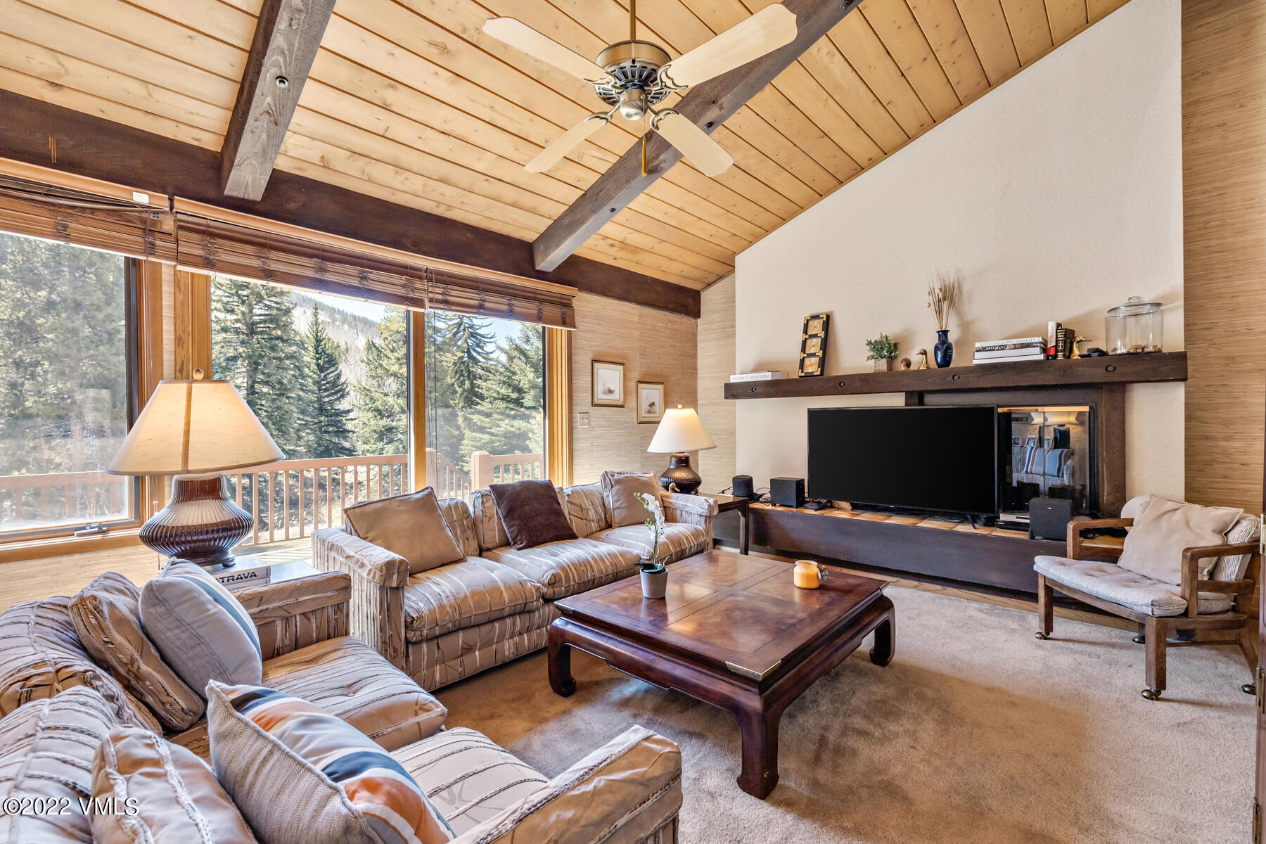1750 South Frontage Road West, Unit E3 Vail, CO 81657 - Photo 7 of 39 a living room with furniture a flat screen tv and a large window