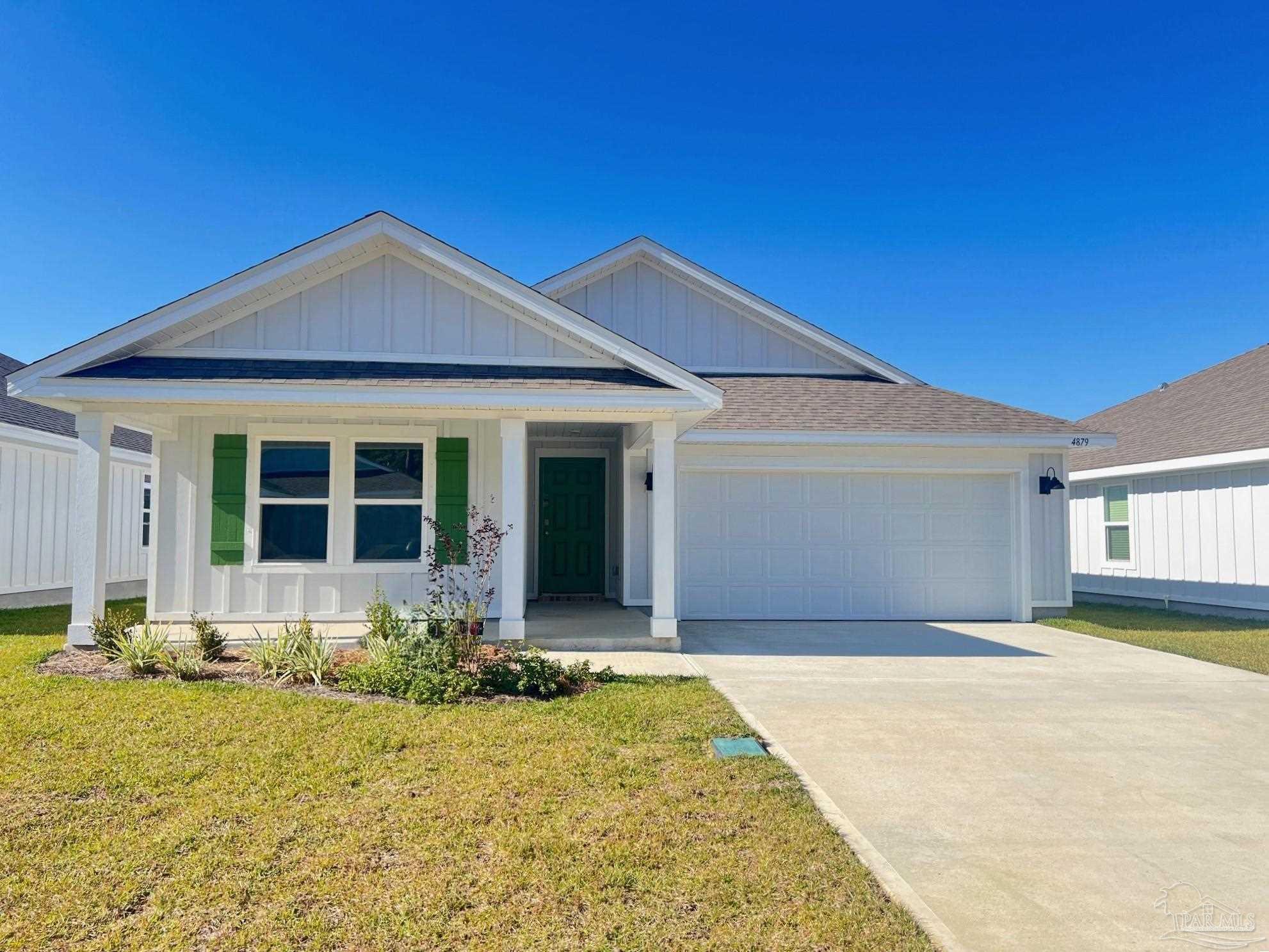 4879 Snipe Road Pace, FL 32571 - Photo 1 of 30 a front view of a house with yard outdoor seating and garage