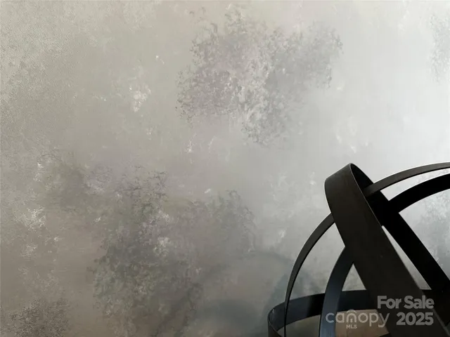 a bedroom with a bed a large window and chair