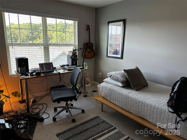 a view of a yard with plants and a fountain