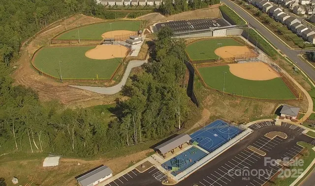 a view of a swimming pool with a bench and lawn chairs