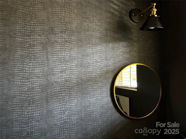 a view of a mirror on brick wall