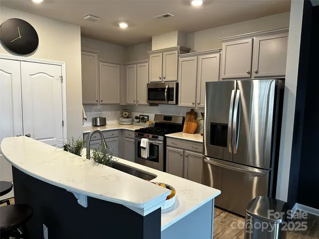 a kitchen with a dining table chairs and utility room