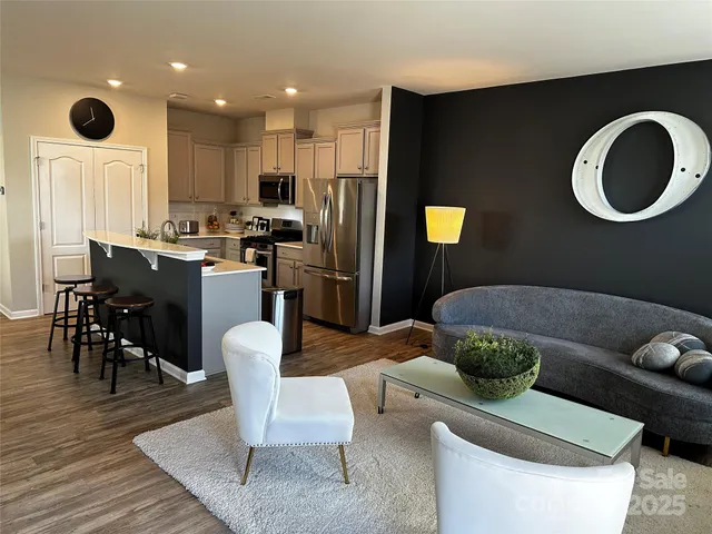 a living room with furniture rug and window