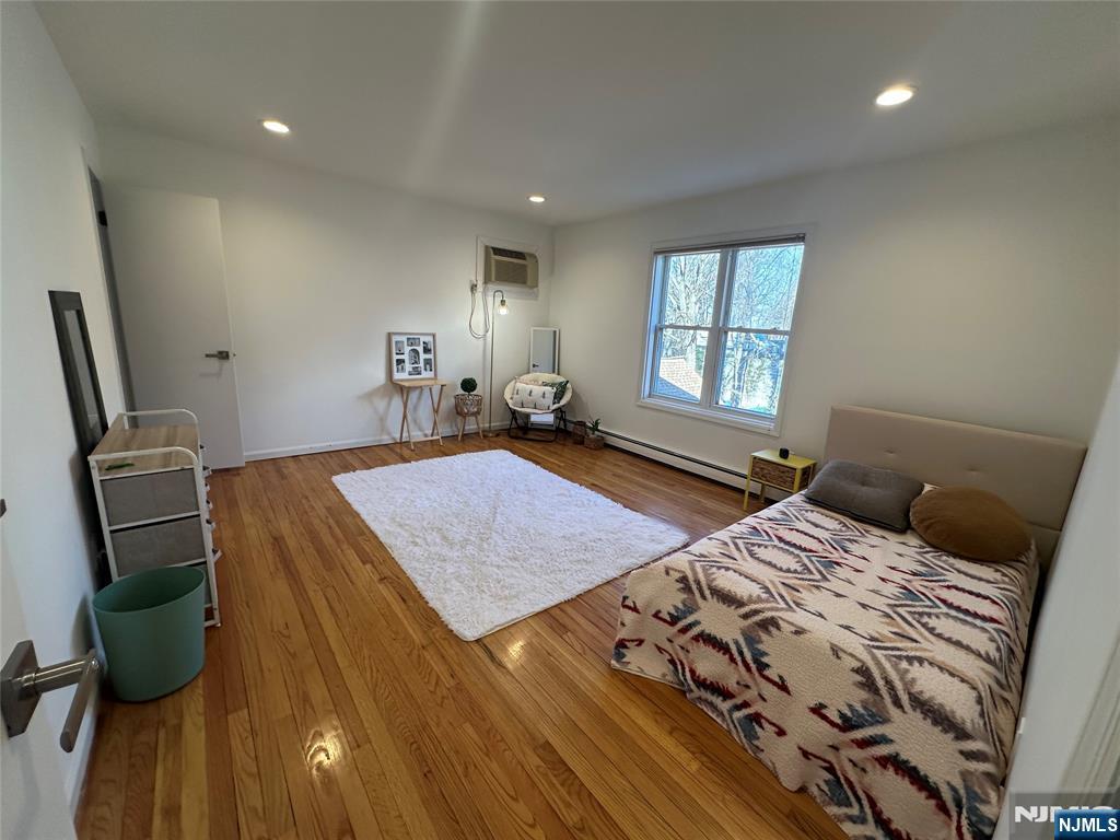531 Day Avenue, Unit 1 Ridgefield, NJ 07657 - Photo 11 of 20 a bedroom with a bed a rug and a flat screen tv