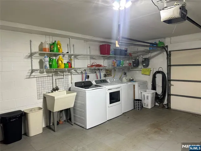 a utility room with cabinets dryer and washer