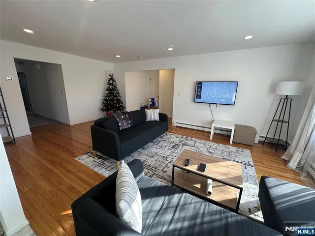 a living room with furniture and wooden floor