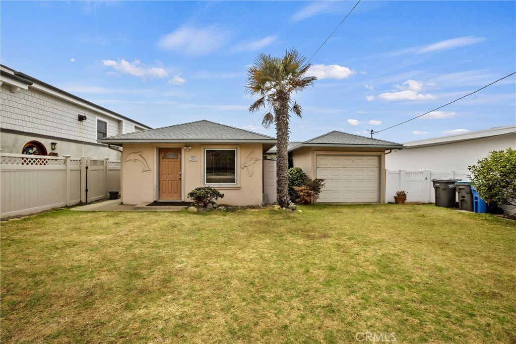 a view of a house with a backyard and a garage