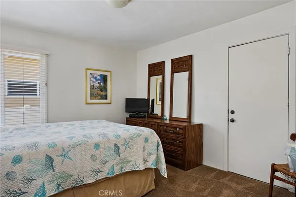 a bedroom with a bed closet and a window
