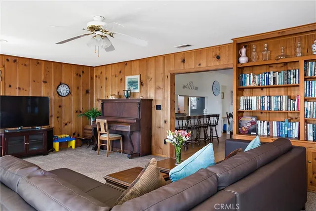a kitchen with granite countertop a sink chairs and cabinets