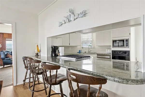 a kitchen with a stove a sink and a microwave