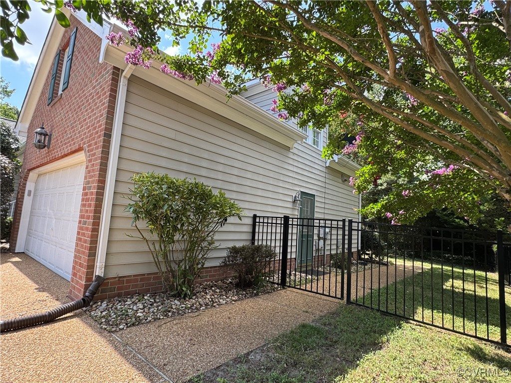 3741 Cherry Walk Williamsburg, VA 23188 - Photo 31 of 37 a view of a house with a small yard and wooden fence and large trees