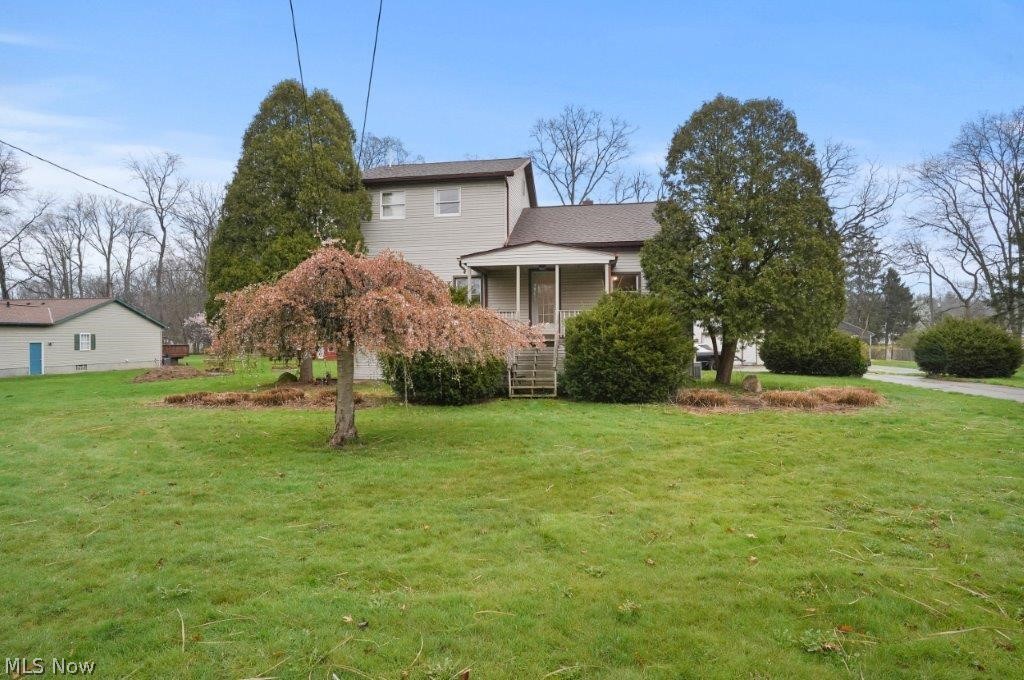 4325 Mayfair Road Uniontown, OH 44685 - Photo 1 of 35 View of side of home featuring a yard