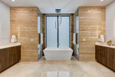 a bathroom with a bathtub sink and mirror