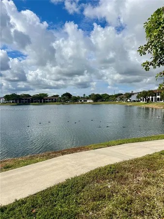 a view of a lake with houses in the back