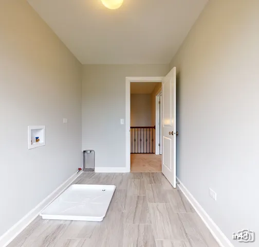 a view of a room with wooden floor and a window