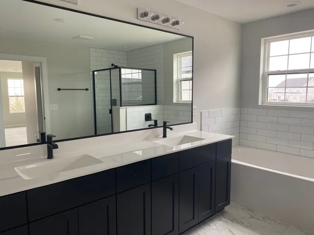 a bathroom with a bathtub and shower