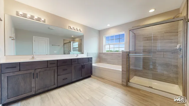 a spacious bathroom with a bathtub shower and sink