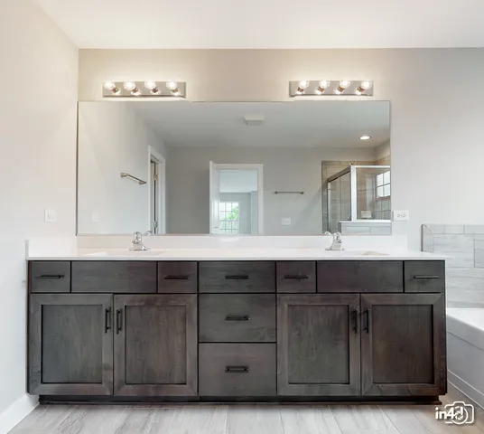 a bathroom with a sink double vanity and a mirror