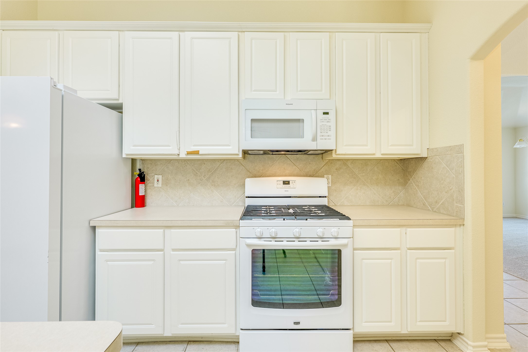 111 Arrowhead Lane Georgetown, TX 78628 - Photo 20 of 40 a kitchen with granite countertop cabinets and white appliances
