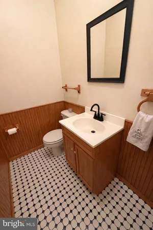 a bathroom with a sink toilet and mirror