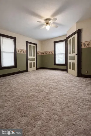 an empty room with windows and closet