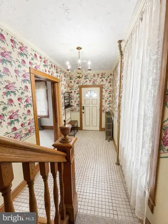 a view of a bedroom with furniture and window