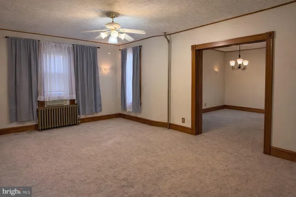 an empty room with windows and closet