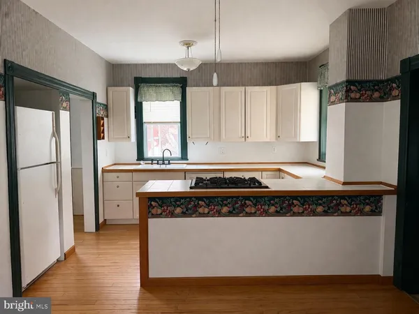 a kitchen with stainless steel appliances granite countertop a refrigerator a stove and a sink