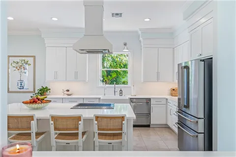 a kitchen with stainless steel appliances a sink stove and refrigerator