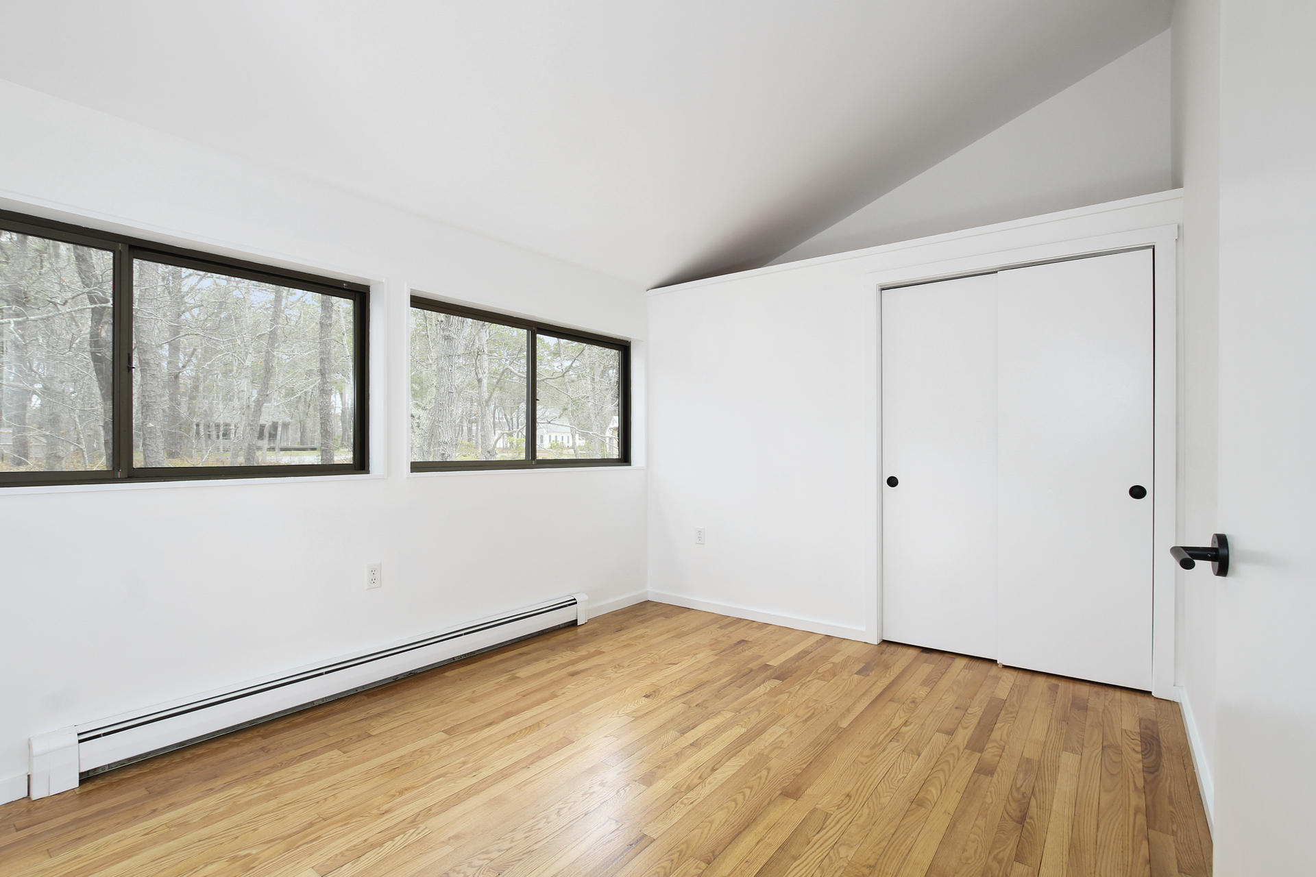 86 Upper Marsh Road Wellfleet, MA 02667 - Photo 17 of 31 a view of empty room with wooden floor and fan