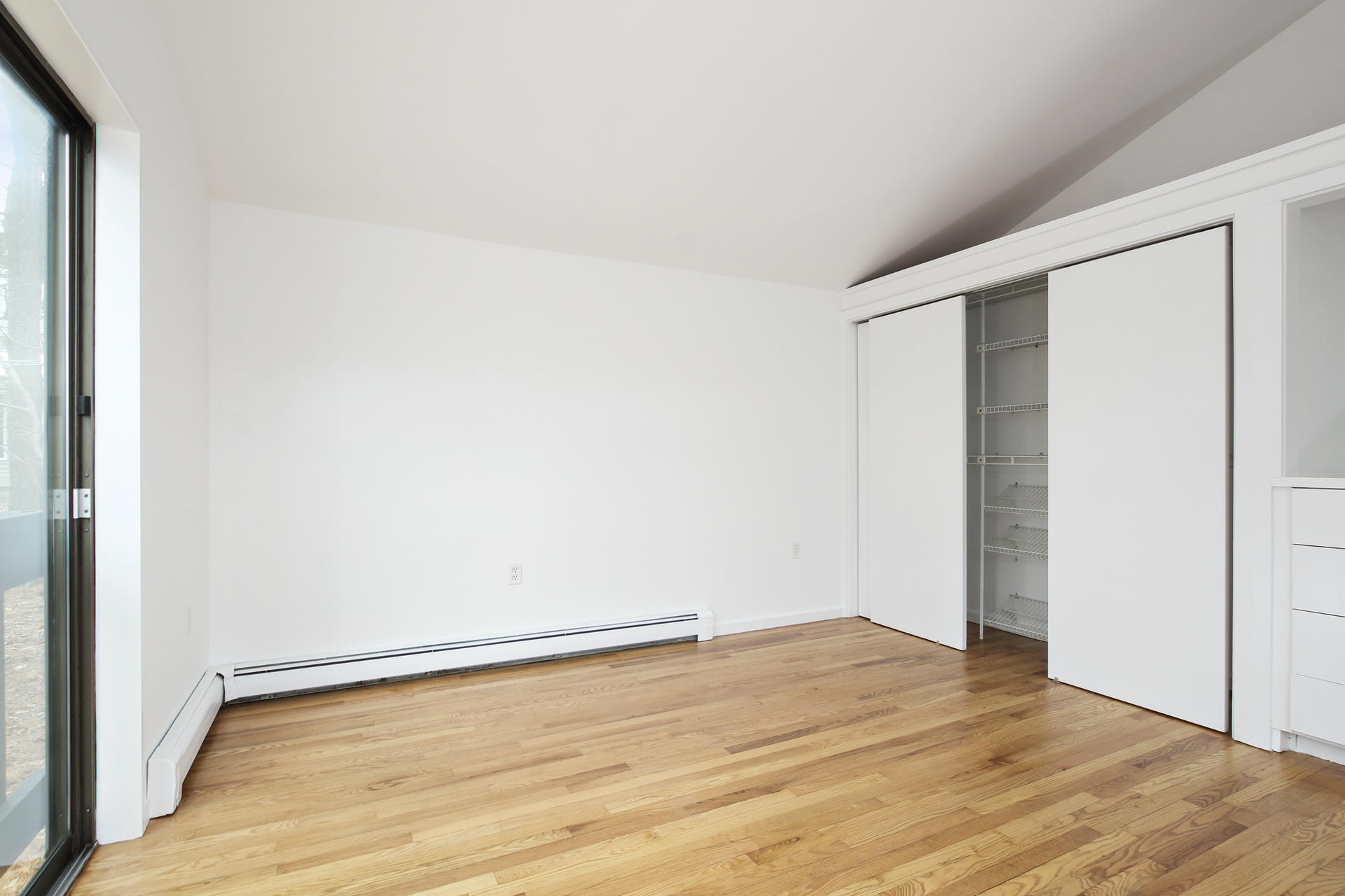 86 Upper Marsh Road Wellfleet, MA 02667 - Photo 19 of 31 a view of an empty room with wooden floor and a window