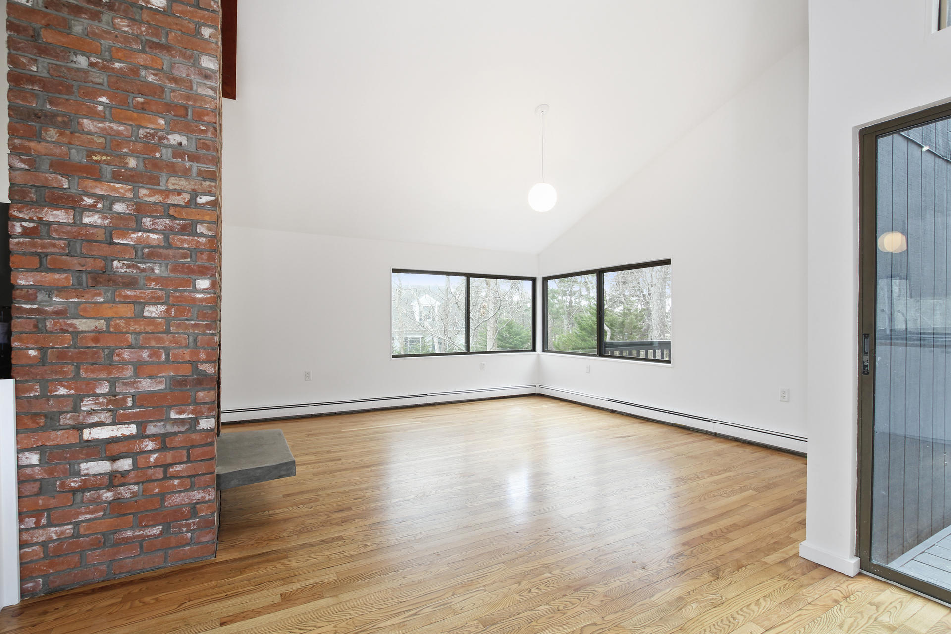 86 Upper Marsh Road Wellfleet, MA 02667 - Photo 9 of 31 a view of an empty room with wooden floor and a window