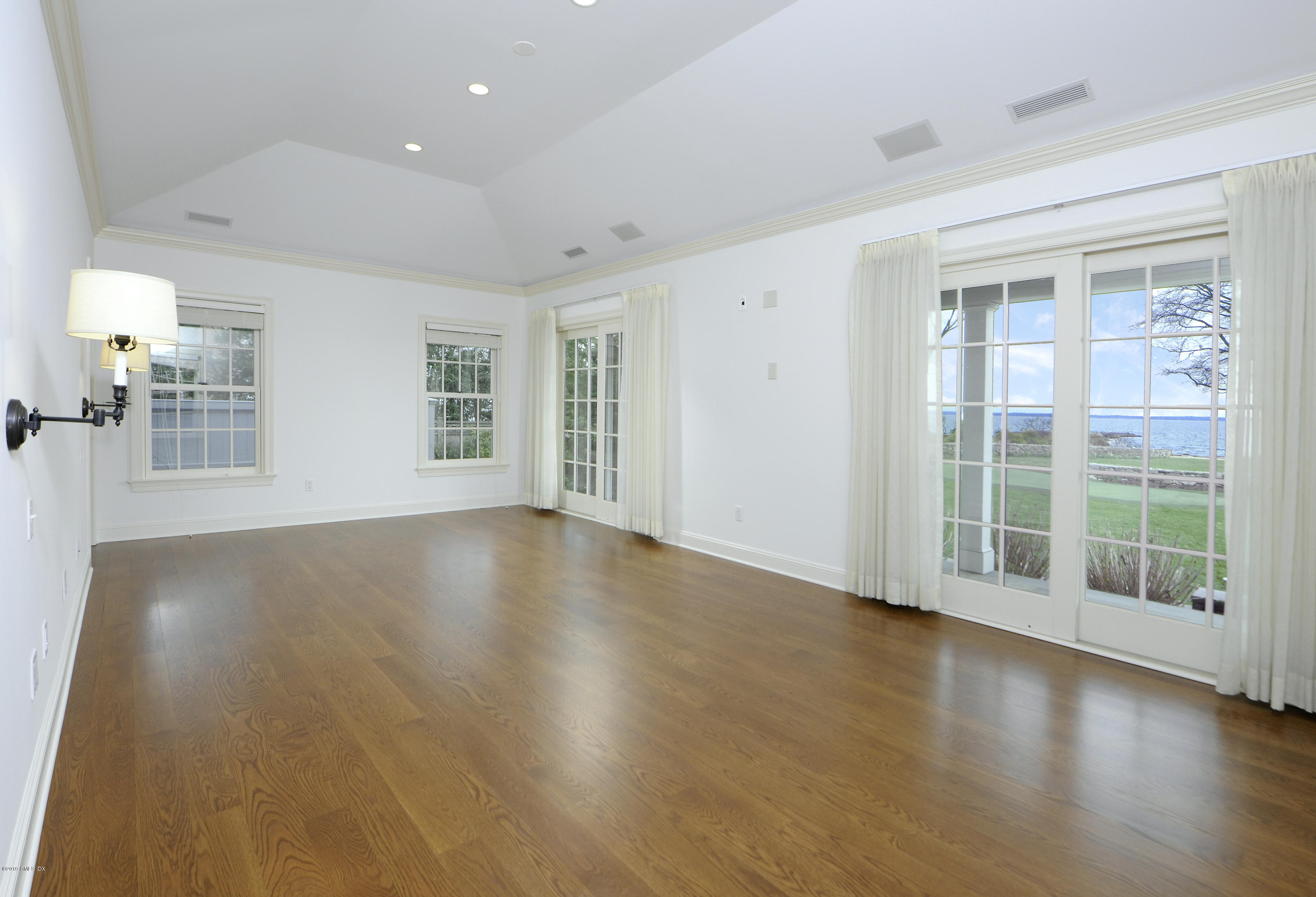 30 Rocky Point Road Old Greenwich, CT 06870 - Photo 13 of 29 an empty room with wooden floor and windows
