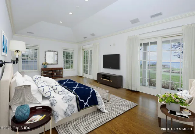 a bedroom with a bed and a television